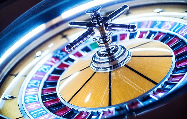 Mobile phone showing CQ9 slot game and live roulette table side by side
